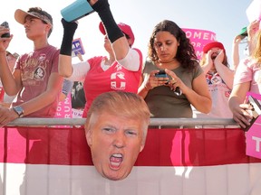 Supporters listen to Republican presidential nominee Donald Trump during a campaign rally the Orlando Amphitheater at Central Florida Fairgrounds November 2, 2016 in Orlando, Florida. With less than a week before Election Day in the United States, Trump and his opponent, Democratic presidential nominee Hillary Clinton, are campaigning in key battleground states that each must win to take the White House. (Photo by Chip Somodevilla/Getty Images)