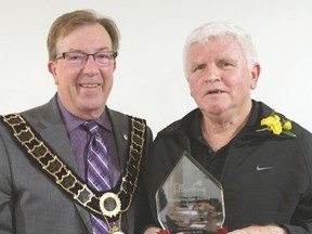 Tillsonburg Mayor Stephen Molnar presents the Town of Tillsonburg Favourite Son Award to Dennis Fairall Sunday afternoon at The Bridges. (CHRIS ABBOTT/TILLSONBURG NEWS)