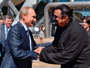 In this Sept. 4, 2015 file photo, Russian President Vladimir Putin, left, and U.S. actor Steven Seagal shake hands after visiting an oceanarium built on Russky Island, in the Russian Far Eastern port of Vladivostok. Putin's spokesman, Dmitry Peskov, told reporters on Thursday, Nov. 3, 2016, that Russia has awarded Russian citizenship to Seagal. (AP Photo/Alexei Druzhinin/Sputnik, Government Press Service Pool Photo via AP, File)