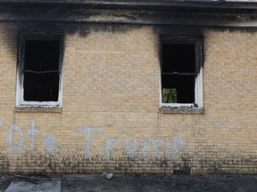 "Vote Trump" is spray painted on the side of the fire damaged Hopewell M.B. Baptist Church in Greenville, Miss., Wednesday, Nov. 2, 2016. Fire Chief Ruben Brown tells The Associated Press that firefighters found flames and smoke pouring from the sanctuary of the church just after 9 p.m. Tuesday. (AP Photo/Rogelio V. Solis)