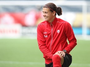 National women's soccer team striker Christine Sinclair chuckles while stretching prior to practice at Investors Group Field in Winnipeg, Man., on Wed., May 7, 2014, ahead of its friendly against the United States the next evening. (Kevin King/Postmedia Network)