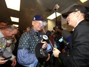 Actor Bill Murray celebrates in the clubhouse with President of Baseball Operations for the Chicago Cubs Theo Epstein after the Cubs defeated the Cleveland Indians 8-7 in Game Seven of the 2016 World Series. (Elsa/Getty Images)