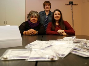 Emily Mountney-Lessard/The Intelligencer
Sandy Watson-Moyles, Jennifer Loner and Leah Morgan, all from Three Oaks, pose for a photo at the shelter in Belleville on Thursday. In front are packages of Sugar Snap necklaces, which will be offered for sale later this month as one of their Domestic Violence Awareness Month fundraisers.