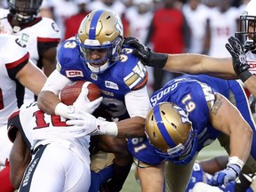 Winnipeg Blue Bomber' Andrew Harris (33) hopes to crack the 1,000-yard rushing mark for the season on Friday in Ottawa. (THE CANADIAN PRESS/Fred Chartrand file photo)