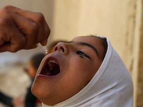 An Afghan health worker administers the polio vaccine to a child during a vaccination campaign in Ghazni on October 17, 2016.
Polio, once a worldwide scourge, is endemic in just three countries now - Afghanistan, Nigeria and Pakistan. ZAKERIA HASHIMI/Getty Images