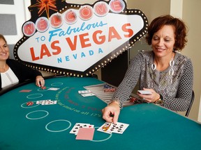 Luke Hendry/The Intelligencer
The United Way's Lyndsey Harker, left, and Judi Gilbert demonstrate blackjack Thursday at their office in Belleville. About 15 tables will be part of the entertainment at the United Way's Viva Las Vegas Charity Casino Saturday at Trenton's National Air Force Museum of Canada.