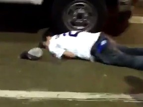 A Cubs fan lies on the ground after being knocked out (Twitter screen grab)