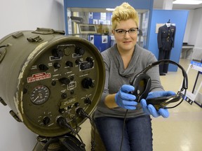 Maya Hirschman, curator of the Secrets of Radar Museum, shows a portable radar set from 1960 on display at the museum. (MORRIS LAMONT, The London Free Press)