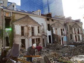 The demolition of the Camden Terrace buildings on Talbot Street continues Thursday in London. The developer says the material will be reused to build an interior feature in the project that will replace it. (DEREK RUTTAN, The London Free Press)