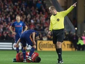 New York City FC forward David Villa stands over Toronto FC midfielder Armando Cooper after the pair clashed on Sunday at BMO Field. Cooper has a way of getting under his opponents’ skin. (Canadian Press)