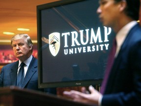 FILE- In this May 23, 2005, file photo, real estate mogul and Reality TV star, now Republican presidential candidate Donald Trump listens at left as Michael Sexton introduces him at a news conference in New York where he announced the establishment of Trump University. Among the people with serious financial problems who taught for Trump University is a case that crossed international borders, an Ontario couple who securities regulators sanctioned over a multimillion-dollar fraud, according to documents reviewed through a joint investigation by The Associated Press and The Canadian Press. (AP Photo/Bebeto Matthews, File)