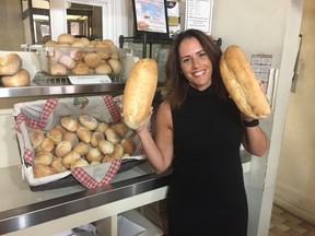 Jodi Marshall shows off the Portuguese-style bread for sale at Marshall?s Pasta Mill, in the former Lusitania Martins Bakery, which made the bread regionally famous.  (HANK DANISZEWSKI, The London Free Press)
