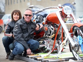 Gary Bernard (right) and his girlfriend Mona Yetman display the custom motorcycle that Bernard won during a national Ride for Dad draw. (Brian Donogh/Winnipeg Sun)
