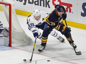 Buffalo Sabres' Sam Reinhart (23) and Toronto Maple Leafs Morgan Rielly (44) chase the puck during the third period of an NHL hockey game Thursday, Nov. 3, 2016, in Buffalo, N.Y. (AP Photo/Jeffrey T. Barnes)