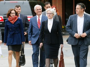 Rolling Stone contributing editor Sabrina Rubin Erdely, left, and Rolling Stone magazine Deputy Managing Editor Sean Woods, right, walk with their legal team to federal court in Charlottesville, Va., Tuesday, Nov. 1, 2016. University of Virginia administrator Nicole Eramo is seeking $7.5 million from the magazine over its portrayal of her in a 2014 story written by Rubin Erdely. (AP Photo/Steve Helber)