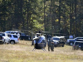 The Greenville County Sheriff's Office assists Spartanburg County investigators Friday, Nov. 4, 2016, as they work on the Wofford Road property in Woodruff, S.C., where a missing woman was found Thursday chained in a large storage container. (Heidi Heilbrunn /The Greenville News via AP)