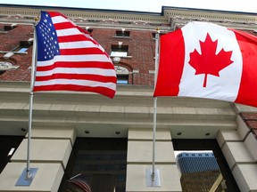 The Canadian flag flies alongside the United States flag outside an Ottawa hotel Sept 26, 2012. (ANDRE FORGET/POSTMEDIA NETWORK FILES)