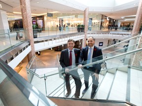 Finley McEwan, left, Cadillac Fairview?s senior vice-president of development, and Masonville Place general manager Brian O?Hoski stand on a new staircase in the former Sears store, as they celebrate the redesign of a portion of the north London shopping mall Friday. (CRAIG GLOVER, The London Free Press)