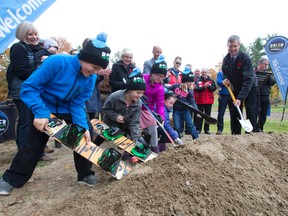 Brady Bonnallie, 10, left, Peyton Bonnallie, 8, Jillian Kennedy, 7, Emily Kennedy, 5, and Stella Kennedy, 6, join Boler Mountain board president Gary Curtis in breaking ground, using skis and snowboards, on a new $6.1 million chalet at the westend not-for-profit ski and activity centre in London, Ont. on Friday November 4, 2016. (CRAIG GLOVER, The London Free Press)