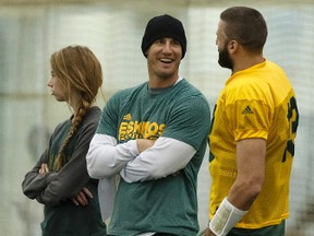 Edmonton's head coach Jason Maas (centre) and quarterback Mike Reilly (13) chat during an Edmonton Eskimos practice in the Field House at Commonwealth Community Recreation Centre in Edmonton, Alberta on Wednesday, November 2, 2016.