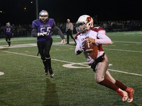 Nathan Rivet, right, of St. Charles College Cardinals, runs for a first down during the senior boys football final against the Lo-Ellen Knights at James Jerome Sports Complex in Sudbury, Ont. on Friday November 4, 2016. The Cards won 28-6. See www.thesudburystar.com for a full story. John Lappa/Sudbury Star/Postmedia Network
