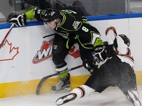 Edmonton's Ethan Cap (left) knocks down Calgary's Mark Kastelic during the first period of a WHL game between the Edmonton Oil Kings and the Calgary Hitmen at Rogers Place in Edmonton, Alberta on Friday, October 28, 2016.
