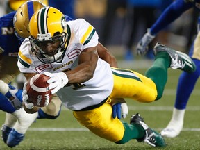 Edmonton Eskimos' Adarius Bowman (4) dives in for the touchdown against Khalil Bass (2) and the Winnipeg Blue Bombers during the first half of CFL action in Winnipeg Friday, September 30, 2016.