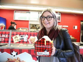 Laurentian University fourth-year communications student Stephanie Thorne enjoys a poutine from the newly opened Smoke's in the Alumni Hall at the Laurentian campus in Sudbury. Gino Donato/Sudbury Star/Postmedia Network