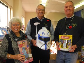Christmas Care co-ordinators Andreana Collins, left, Al Mintz and Carl Bagshaw show off just some of the toys up for grabs this year. The seasonal charity provides Christmas presents and warm clothing for children and hands out festive food hampers to some 1,600 low income famlies every December.