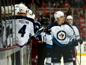 Brandon Tanev and the Winnipeg Jets celebrate one of his two goals Friday night in Detroit. (Gregory Shamus/Getty Images)