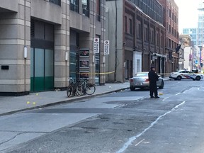 Toronto Police evidence markers are scene on Mercer St., south of King St. W. west of John St. Saturday, Nov. 5, 2016 after a shooting sent a man to hospital. (Cynthia McLeod/Toronto Sun)
