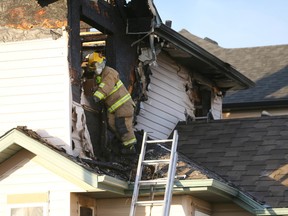 Fire crews are shown on scene at Coverton Heights N.E. at about 2 a.m. in Calgary, Alta Saturday November 5, 2016 following a large house fire. Crews were met with a fully-involved two-storey home that had partially collapsed and one person is still unaccounted for. Jim Wells/Postmedia