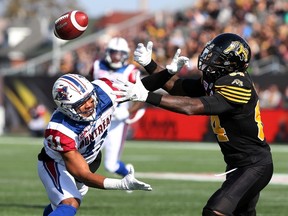 Hamilton Tiger-Cats wide receiver Kevin Elliott is unable to make the catch while being defended by Montreal Alouettes defensive back Tyree Hollins during CFL action in Hamilton on Nov. 5, 2016. (THE CANADIAN PRESS/Peter Power)