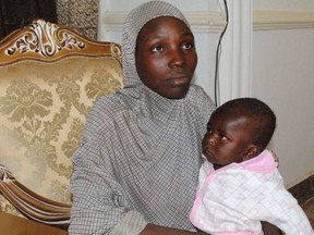 A recently rescued Nigerian Chibok girl with her child at a local Nigerian government council house in Maiduguri, Nigeria, Saturday, Nov. 5, 2016. Nigerian troops rescued one of the Chibok schoolgirls kidnapped by Boko Haram extremists more than two years ago in a pre-dawn raid Saturday on a forest hideout. She had a 10-month-old baby boy born to a Boko Haram fighter, said a statement from army spokesman Col. Sani Kukasheka Usman. (AP Photo/Jossy Ola)