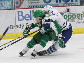 Michael Pezzetta, left, of the Sudbury Wolves, is held by Stephen Gibson, of the Mississauga Steelheads, during OHL action at the Sudbury Community Arena in Sudbury, Ont. on Saturday November 5, 2016. John Lappa/Sudbury Star/Postmedia Network