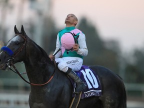 Jockey Mike Smith riding Arrogate celebrates after winning the Breeders' Cup Classic on Saturday. (GETTY IMAGES)