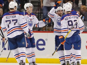 The Edmonton Oilers celebrate a goal scored by left wing Milan Lucic (27) against the New York Islanders during the second period of an NHL hockey game, Saturday, Nov. 5, 2016, in New York.