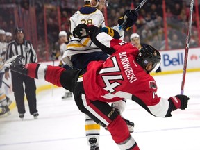 Buffalo Sabres centre Zemgus Girgensons collides with Senators defenceman Mark Borowiecki during Saturday night’s game at the CTC. (THE CANADIAN PRESS)