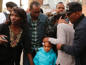 An unidentified women is comforted after learning that three people were killed and several others injured in a stabbing at a house Saturday, Nov. 5, 2016, in Newark N.J. The stabbings occurred around 4 p.m. Saturday at a Hedden Terrace residence. Essex County's major crimes task force and city police are investigating the stabbings. (Robert Sciarrino /NJ Advance Media via AP)