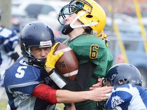 A pair of Quinte defenders sandwich a Centennial ballcarrier during the Bay of Quinte junior football final Saturday at MAS 2. (Submitted photo)