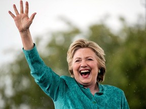 Democratic presidential candidate Hillary Clinton waves as she cuts her speech short due to rain at a rally at C.B. Smith Park in Pembroke Pines, Fla., Saturday, Nov. 5, 2016. If Hillary Clinton wins Tuesday's election, Canada's relationship with the White House could soon be cast as a family affair, thanks to the presidential candidate's well-documented French-Canadian ancestry. (THE CANADIAN PRESS/AP)