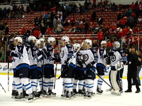 Connor Hellebuyck #37 of the Winnipeg Jets celebrates with teammates after a 5-3 win over the Detroit Red Wings at Joe Louis Arena on Nov. 4, 2016 in Detroit, Michigan. (Photo by Gregory Shamus/Getty Images)