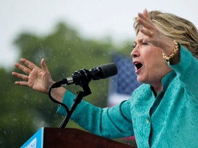 Democratic presidential candidate Hillary Clinton speaks during a heavy rain at a rally at C.B. Smith Park in Pembroke Pines, Fla., Saturday, Nov. 5, 2016. (AP Photo/Andrew Harnik)