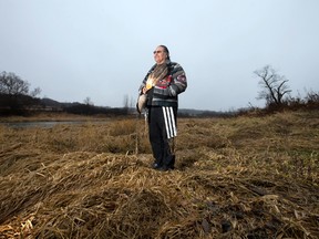 Chippewas of the Thames First Nation band member Myeengun Henry stands on the bank of the Thames River near Plover Mills Drive, where energy company Enbridge's Line 9 runs, northeast of London, Ont. (CRAIG GLOVER, Free Press file photo)