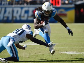Chargers running back Melvin Gordon (28) runs with the ball as Titans cornerback Perrish Cox defends during first half NFL action in San Diego on Sunday, Nov. 6, 2016. (Denis Poroy/AP Photo)