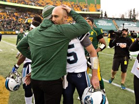 Argos QB Ricky Ray is embraced by Eskimos head coach, and former teammate, Jason Maas after the final regular season game for both teams on Saturday, (The Canadian Press)