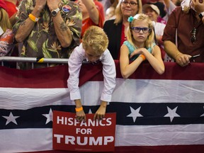 Supporters of Republican presidential candidate Donald Trump wait for his arrival to a campaign rally at the Florida State Fairgrounds, Saturday, Nov. 5, 2016, inTampa, Fla. (AP Photo/ Evan Vucci)