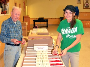 This year's Royal Canadian Legion Poppy campaign officially got underway Oct. 28, as Legion members and volunteers spent the day filling poppy boxes to be distributed to businesses, municipal offices and schools. At the Mitchell Legion, br. 128, Poppy Chair Tracey Phillips (right) and volunteer Jim Wright had their hands full preparing 75 poppy boxes for businesses and offices in West Perth. GALEN SIMMONS MITCHELL ADVOCATE