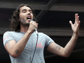 Comedian Russell Brand speaks in Parliament Square during a protest against the Conservative Government and it’s austerity policies in London, Saturday, June 20, 2015. (AP Photo/Tim Ireland)
