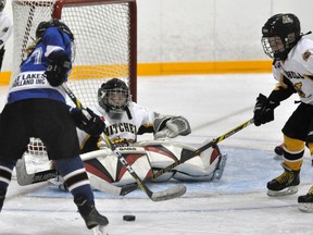 Mitchell Atom AE goalie Joel Meinen keeps his eye on the puck despite being down and out in his crease during WOAA regular season action against BCH last Saturday. The home side won, 6-3. ANDY BADER MITCHELL ADVOCATE
